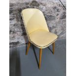 A Retro bedroom tub chair. Designed with wooden turned legs and black trims.