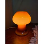 A 1960's/ 70's retro art glass mushroom style table lamp. White interior and amber exterior. In a