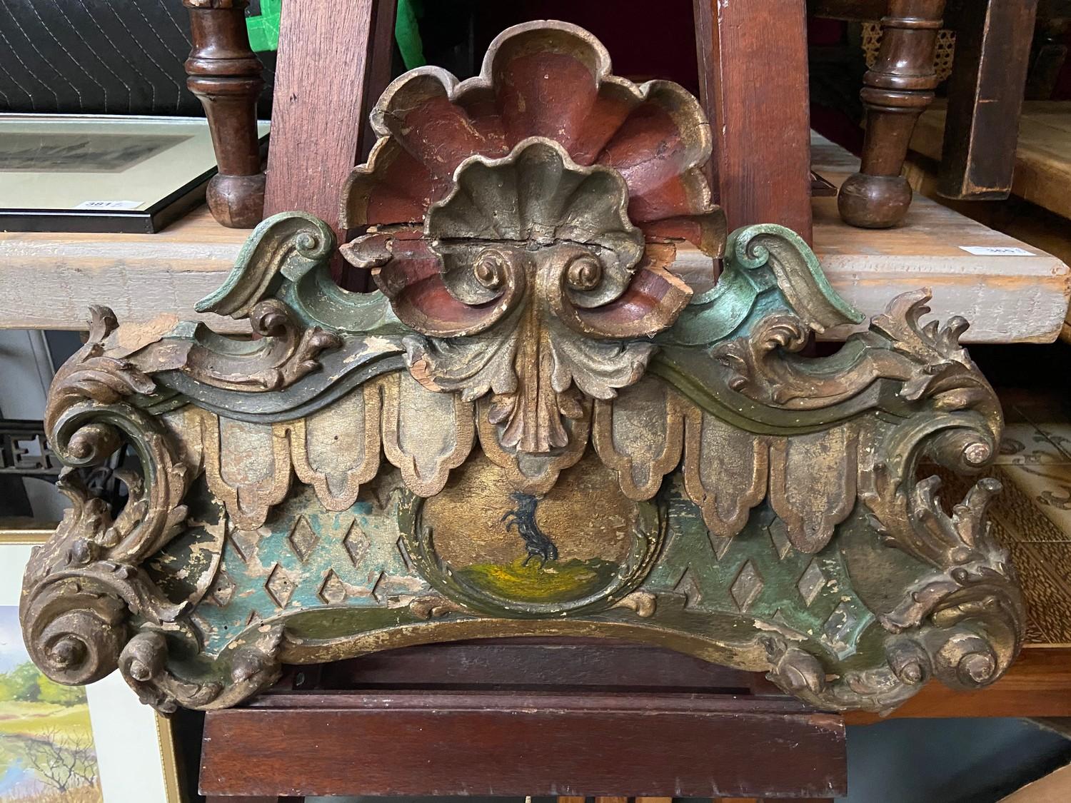 A 17th century hand carved wooden finial panel showing signs of original paint work. Centre panel