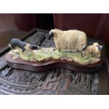 A Vintage Border Fine Arts figurine of a border coley herding sheep. Dated 1982, and signed