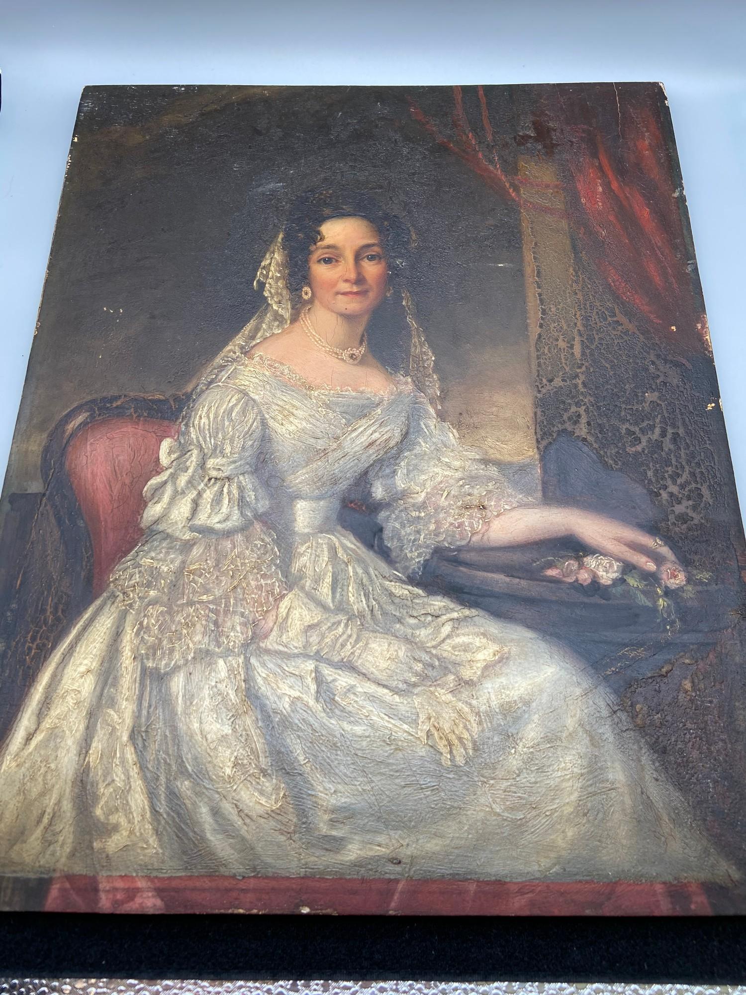 An 18th century Georgian oil painting on a wooden panel of a lady seated, wearing a lace style dress