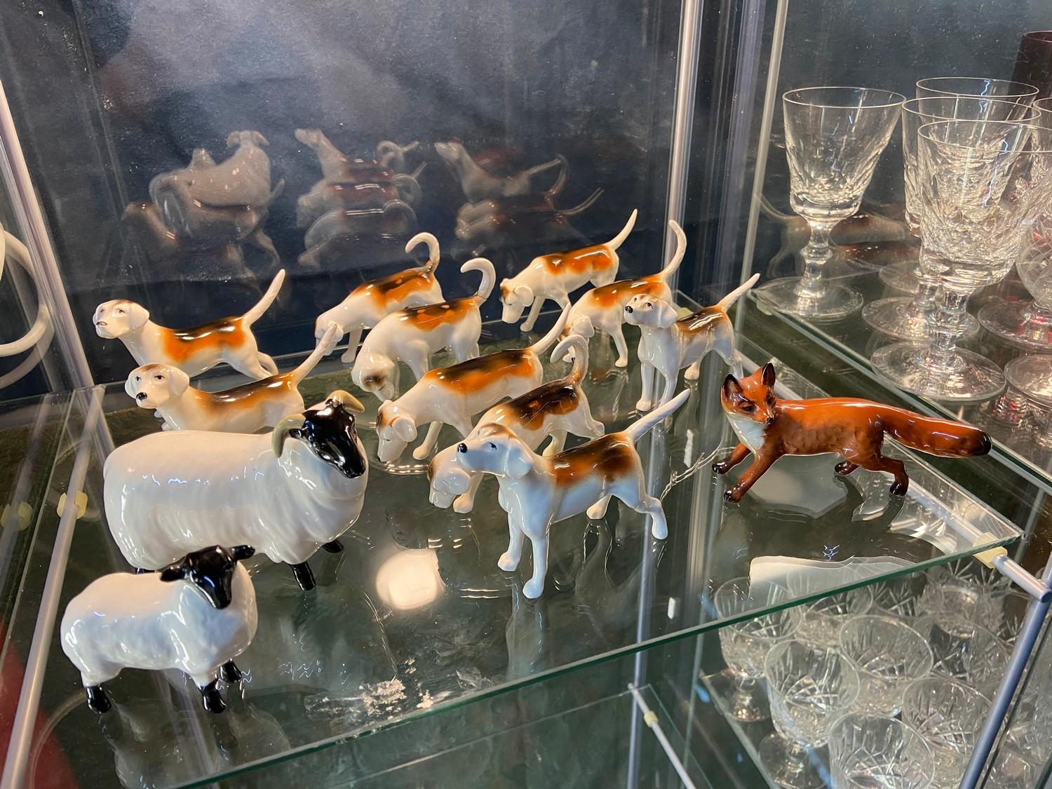 A Shelf of Beswick animals which includes Fox, bugle hunting dogs and sheep.