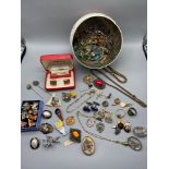 A quantity of mixed costume jewellery and collectable pin badges which includes a set of magic