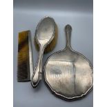 A Birmingham silver three piece dressing table set. Includes mirror, brush and comb.