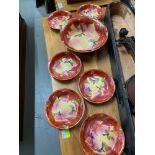 A Scottish hand painted bowl and 6 matching serving bowls. Prodcued by B.P.Co LTD.