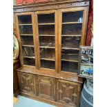 A Victorian solid oak library bookcase. Designed with three glass panel doors to the top section,