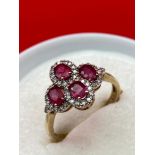 A Lovely example of a ladies 9ct gold diamond and ruby ring. Consists of four oval cut rubies