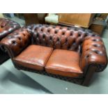 A Three piece Chesterfield suite. Consists of a two seat sofa and two single club chairs.