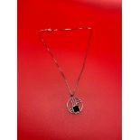 A Ladies Art Deco design 9ct white gold and onyx pendant together with a 9ct white gold necklace. [