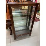 Antique Shop display cabinet designed with mirror, glass shelf and metal bracket interior.