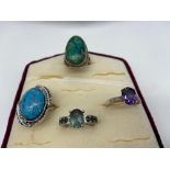 A Lot of four 925 silver rings designed with various precious gem stones.