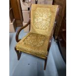 Antique style lounge chair with arm rests.