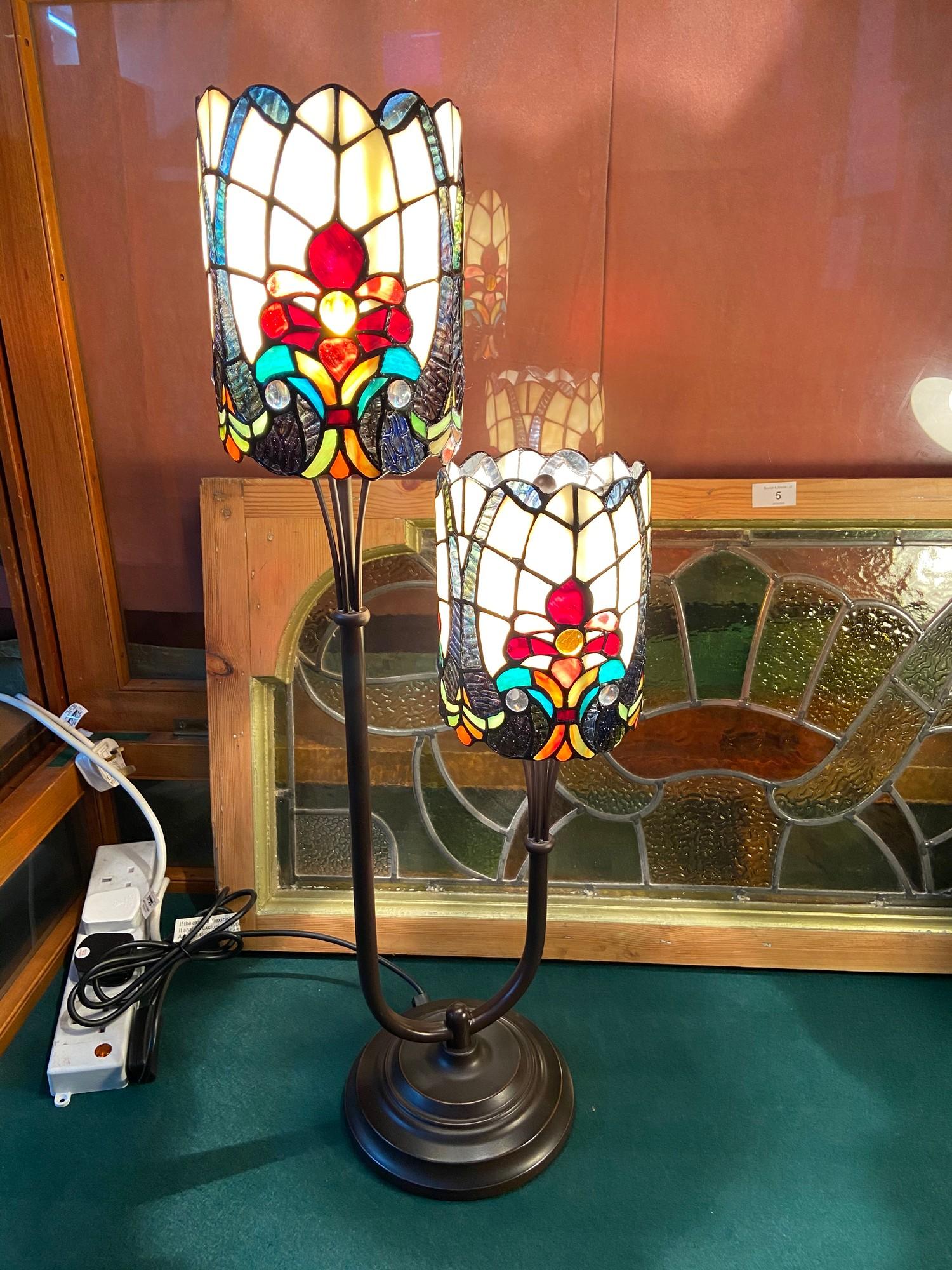 A Two tier Tiffany style table lamp. In a working condition. [74cm height]