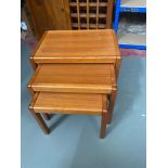 A Mid century teak nest of three tables.