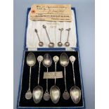 A Box set of 6 shooting match tea spoons together with 4 Indian silver Rupee coin condiment spoons.