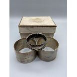 Two Art Deco design Birmingham napkin rings together with one small Birmingham silver napkin ring.