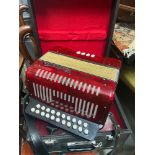 A Parrot squeeze box instrument with hard carry case
