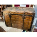 A Large Victorian dome topped travel trunk, Designed with a canvas, wood and metal exterior. Shows a