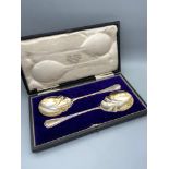 A Boxed set of two London silver serving spoons produced by Josiah Williams & Co. Dated 1913.