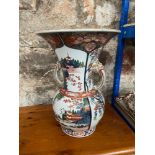 A Large 19th century Japanese two handled vase. Designed with raised relief woo dog heads and