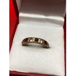 A Ladies 9ct gold ring set with 5 garnets and 4 clear stones. [2.37grams] [Ring size M]