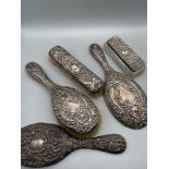 A Lot of 5 various silver hallmarked dressing table items. Includes two brushes, Two hand mirrors