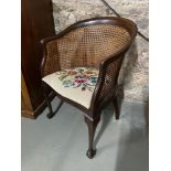 Antique bergere tub chair designed with a tapestry removable cushion seat. Designed with ball and