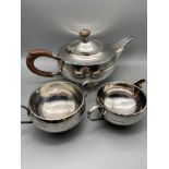 A Birmingham silver three piece tea service. Produced by Hukin & Heath Ltd. Dated 1924. All are