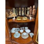 Two shelves of oriental wares to include Famille rose cups and saucers, Hand painted and lacquered