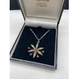 A Ladies 9ct gold [Tested] suffragette flower shaped pendant, Designed with seed pearls and 5
