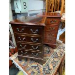 A Pair of reproduction mahogany four drawer bedside units.