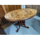 A Victorian bur walnut top console table designed with four pedestal and leg supports. Top showing