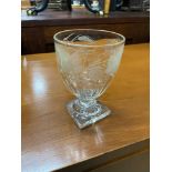 A Georgian ladies wine glass/ goblet. Designed with foliage etchings and square base.