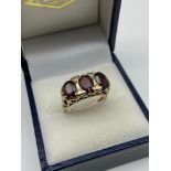 A Ladies 9ct gold and garnet set ring. Designed with three large garnet stones. Size N. [Weighs 3.