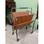 A Mid century metal frame and leather sectioned magazine rack. Designed with original castor wheels.