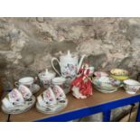 A Shelf of porcelain collectables to include Royal Doulton figure, Poland floral design coffee set