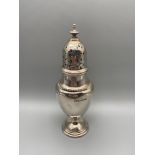 A Sheffield silver sugar shaker produced by Brook & Son, dated 1925. [17cm height]