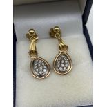 A Pair of 9ct gold and diamond cluster ornate earrings. [Weighs 4.43grams]