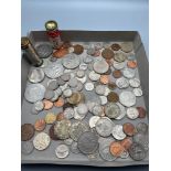 A Quantity of mixed world coins together with two saving bank canisters