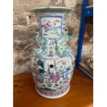 A 19th century Large Chinese Famille Rose hand painted vase. Designed with raised relief dragons and