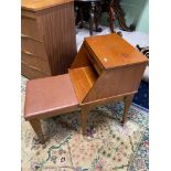 A Mid century teak telephone table with pull out writing slope and cushioned seat stool.