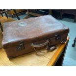 A Vintage leather travel case showing various stickers