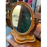 A Victorian mahogany swivel dressing table mirror with storage area.