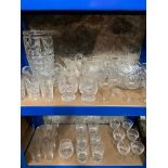 Two shelves of ornate cut crystal vases, bowls, whisky, and port glasses