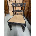 A Victorian Ebony highly carved lounge chair.
