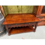 A Contemporary hardwood lounge table designed with two under drawers and under shelf.