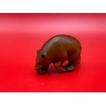 A Japanese hand carved netsuke of a Bear designed with black bead eyes and signed by the artist.
