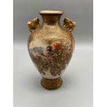 An early 20th century Japanese Satsuma hand painted urn vase. Designed with foo dog handles. Hand