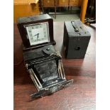 A Vintage bakelite Smiths Electric clock, Kodak box camera and Houghtons Ltd London bellow camera.