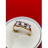 A Tested 9ct gold ladies ring set with three large clear stones. [3.24grams] [Ring size Q]